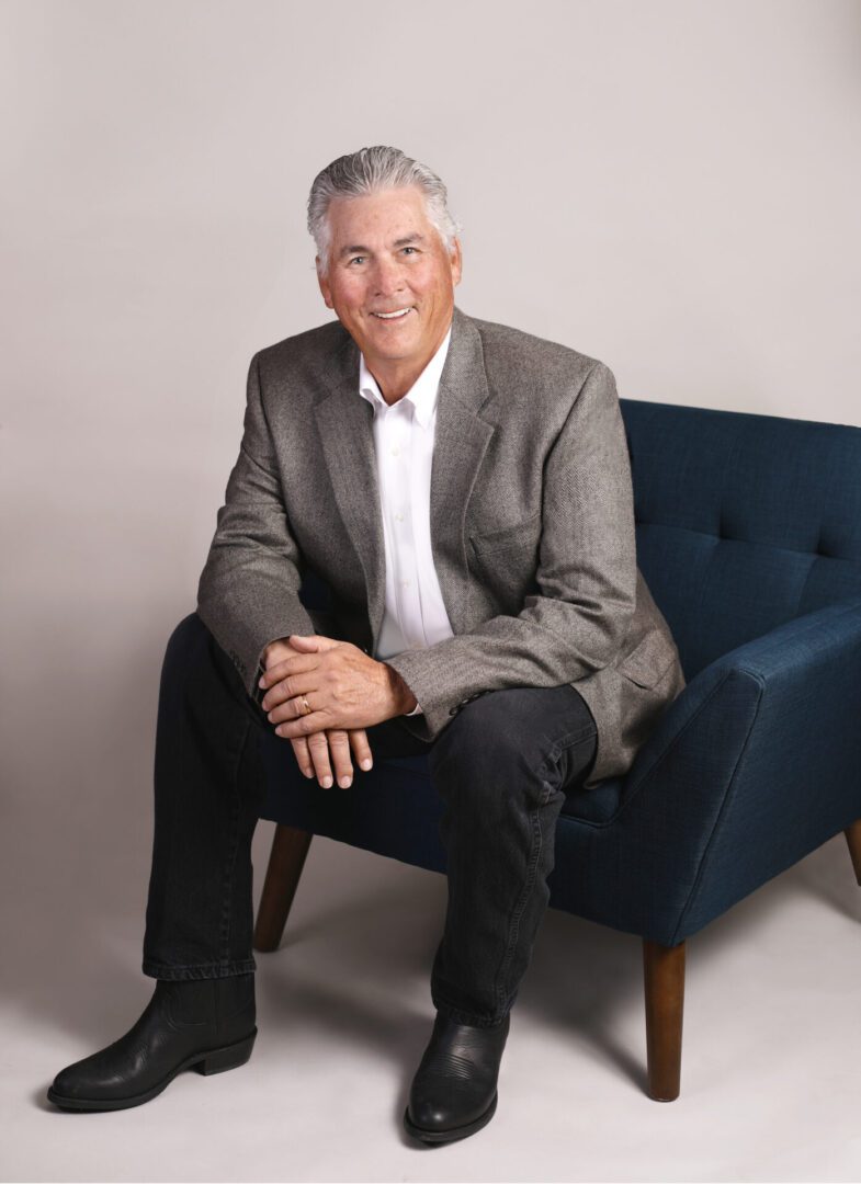 Man sitting in a blue chair